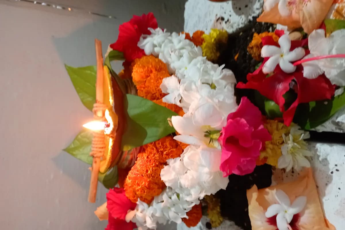 Consecrated brass kalash adorned with coconut, mango leaves, and flowers on Akshaya Tritiya