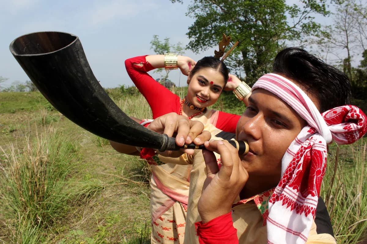 Traditional Assamese Rongali Bihu celebration with folk music, dhol, and festive attire