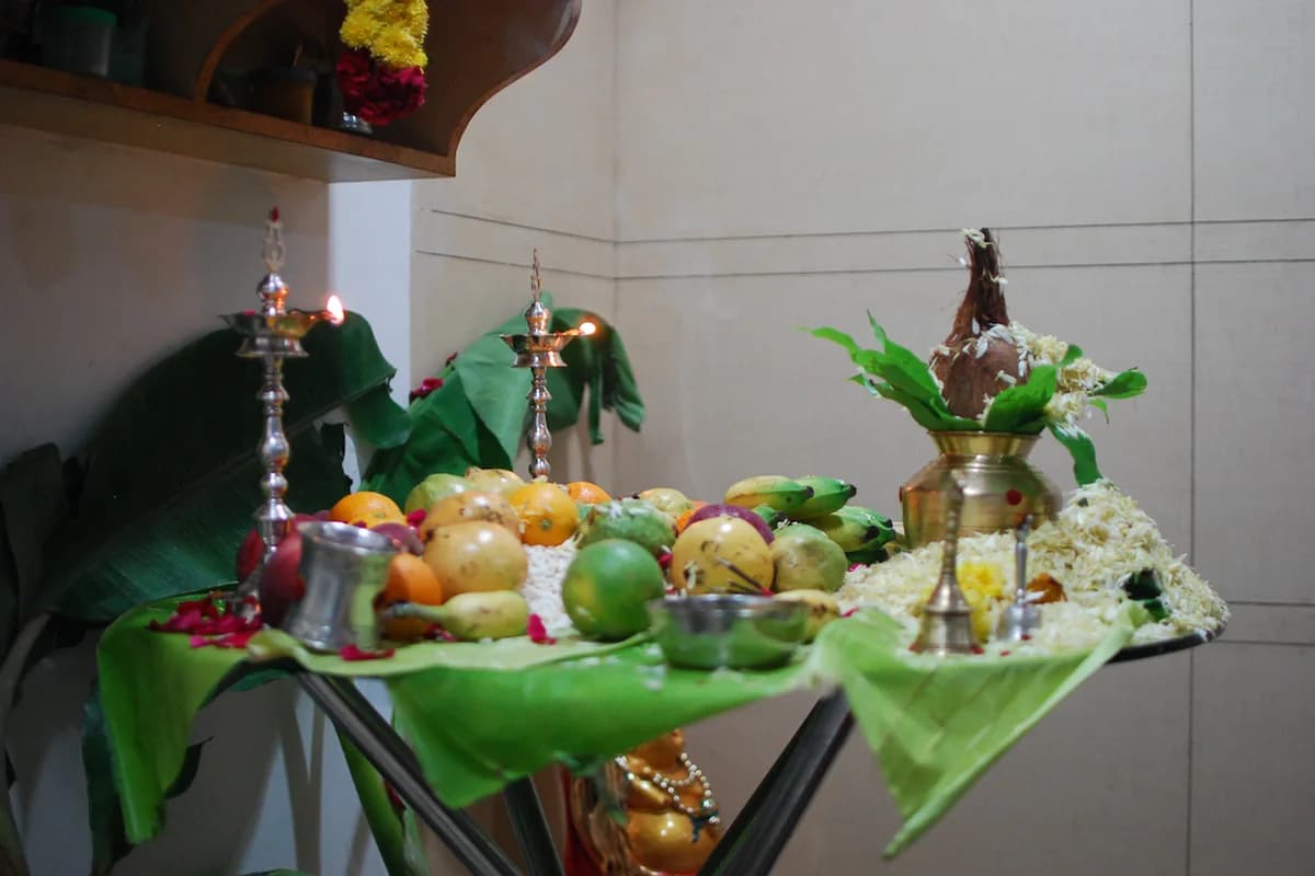 Consecrated Ghatasthapana brass kalash with barley shoots and flowers for Chaitra Navratri