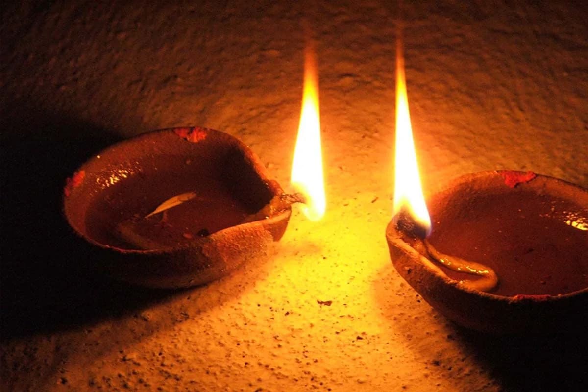 Rows of traditional South Indian terracotta oil lamps illuminating the sacred threshold