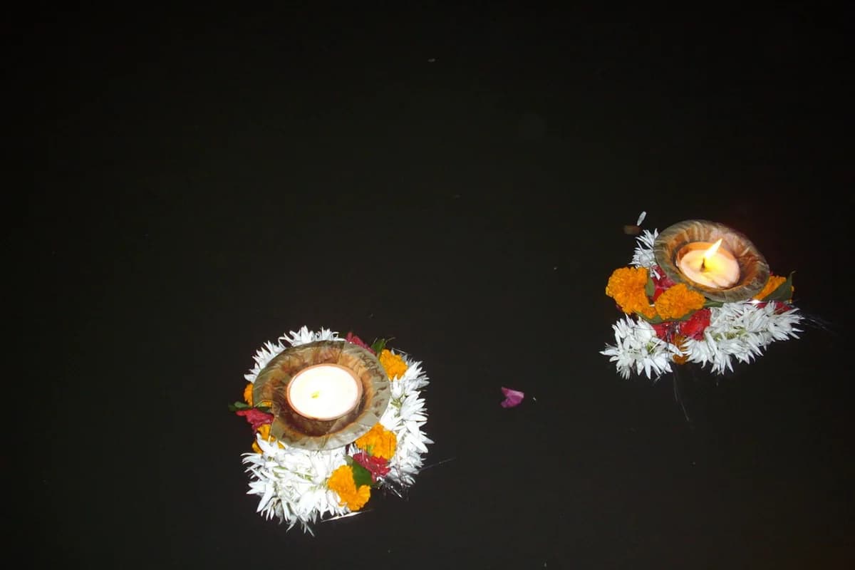 Earthen oil lamps glowing softly in the pre-dawn twilight for Naraka Chaturdashi Abhyanga Snan