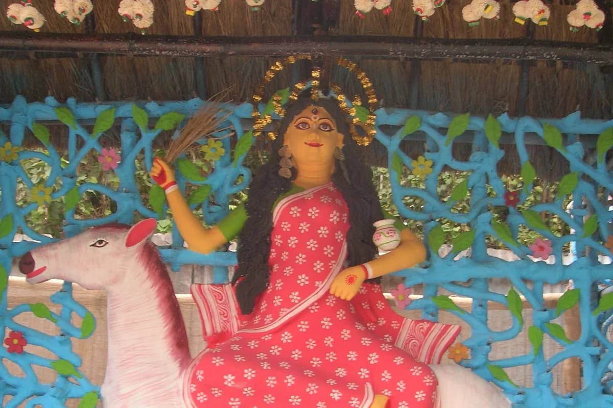 Traditional deity of Mata Sheetala adorned with neem leaves, brass kalash, and peaceful offerings
