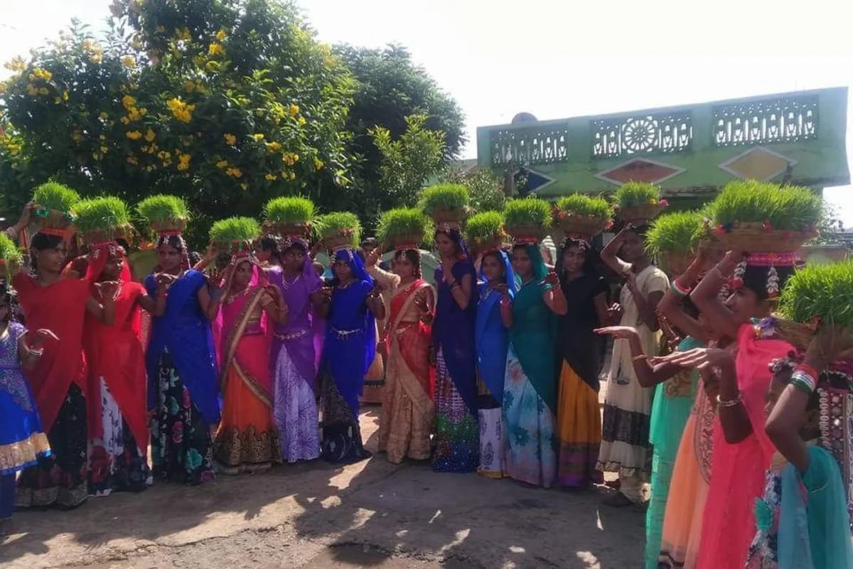 Women celebrating monsoon Teej festival with traditional embroidered skirts, bangles, and folk songs