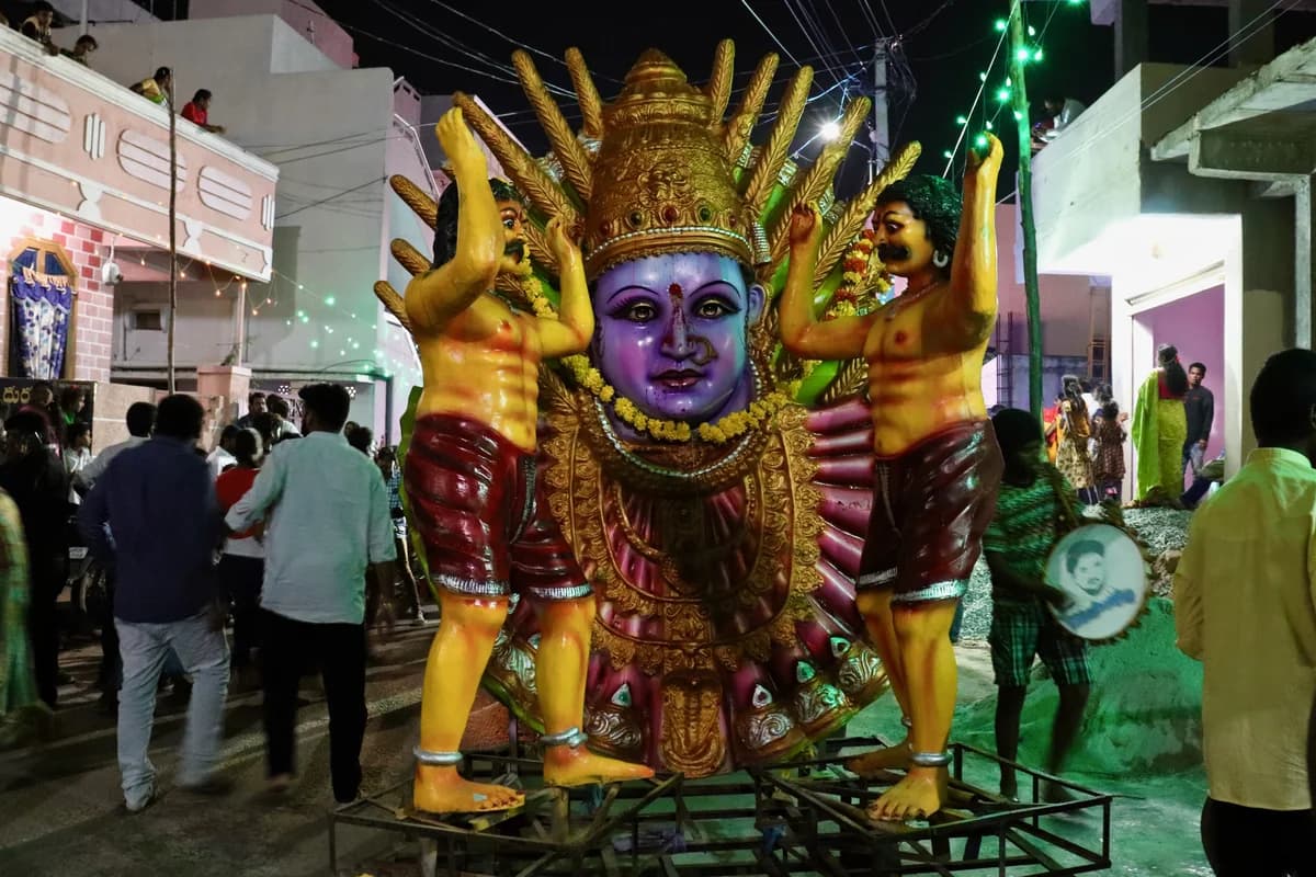Devotees carrying decorated earthen Bonalu pots adorned with turmeric, vermilion, and neem leaves