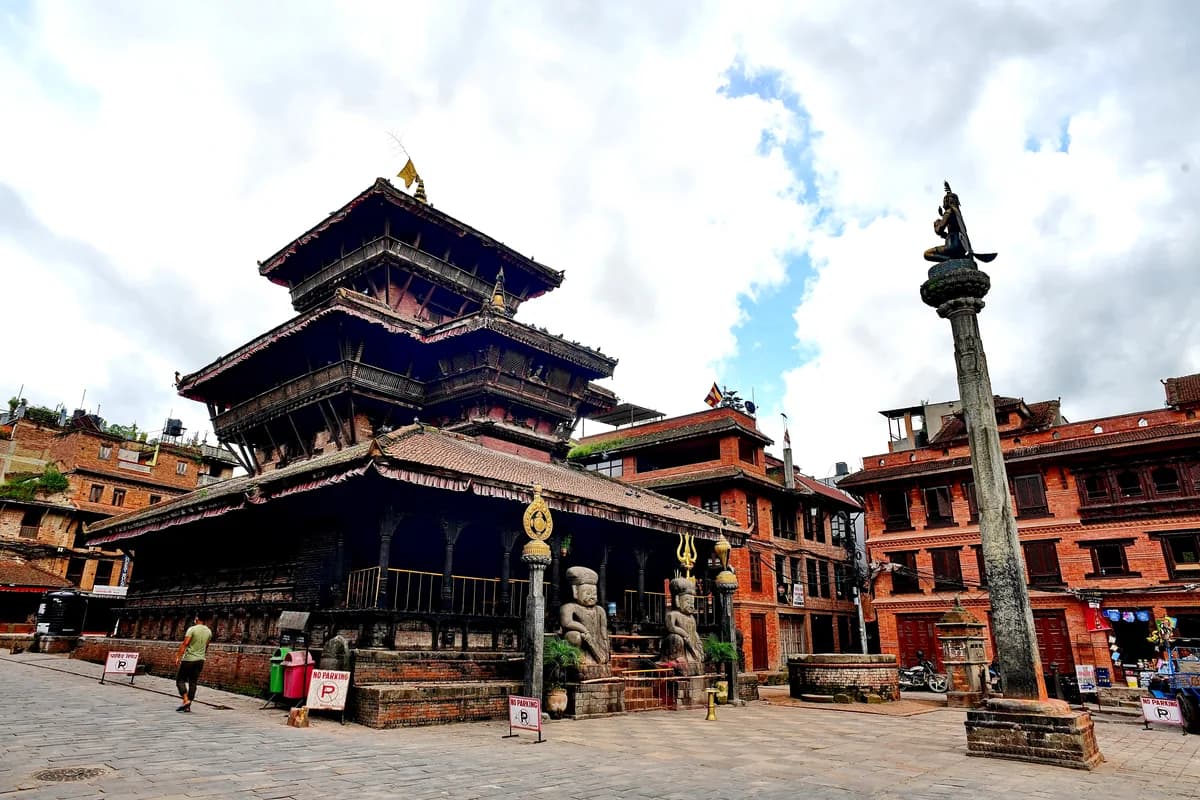 Sacred carved wooden sanctum of Lord Dattatreya adorned with brass lamps